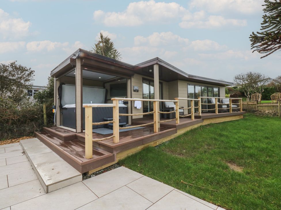 An outdoor area with a hot tub and decking at The Bay in Benllech