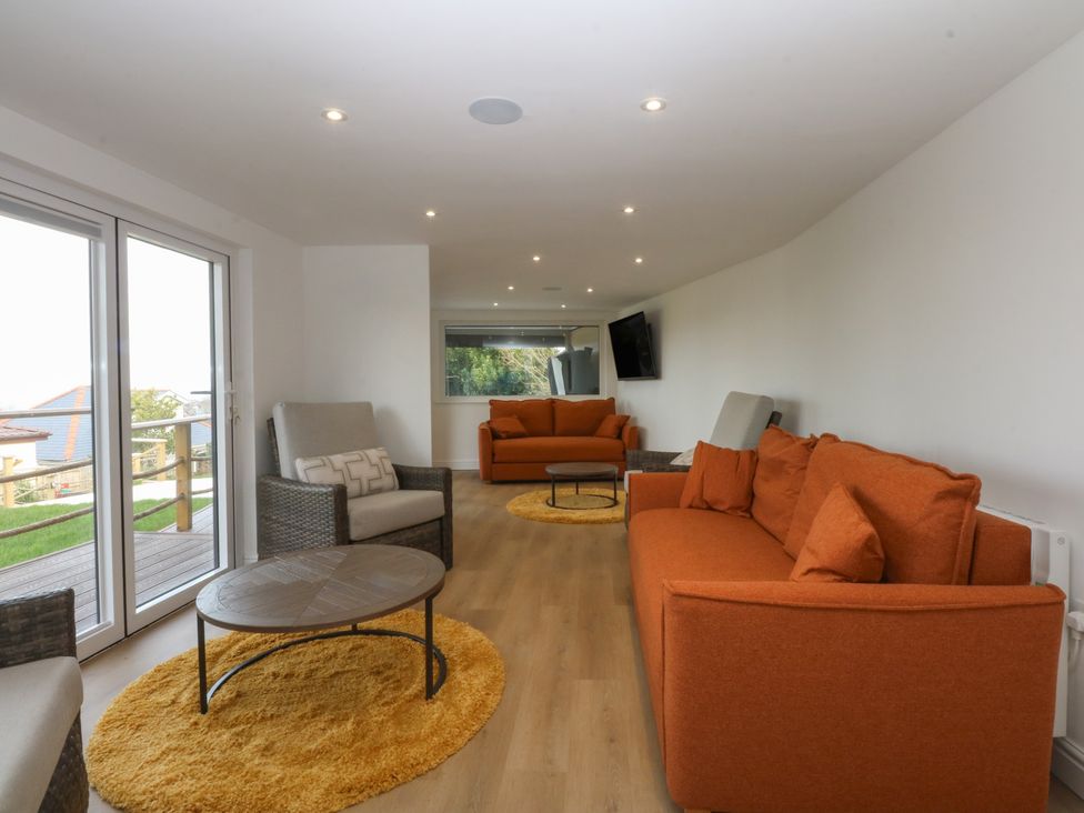 A living room with sofas and a coffee table at The Bay in Benllech