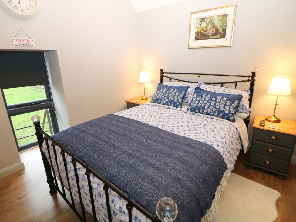 A bedroom with a bed and bedside tables at Horsedale Barn in Bonsall