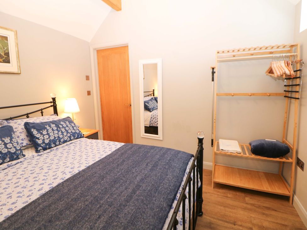 A bedroom with a bed and wardrobe at Horsedale Barn in Bonsall