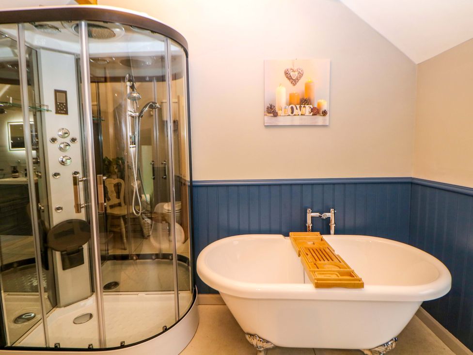 A bathroom with a shower and bathtub at Horsedale Barn in Bonsall