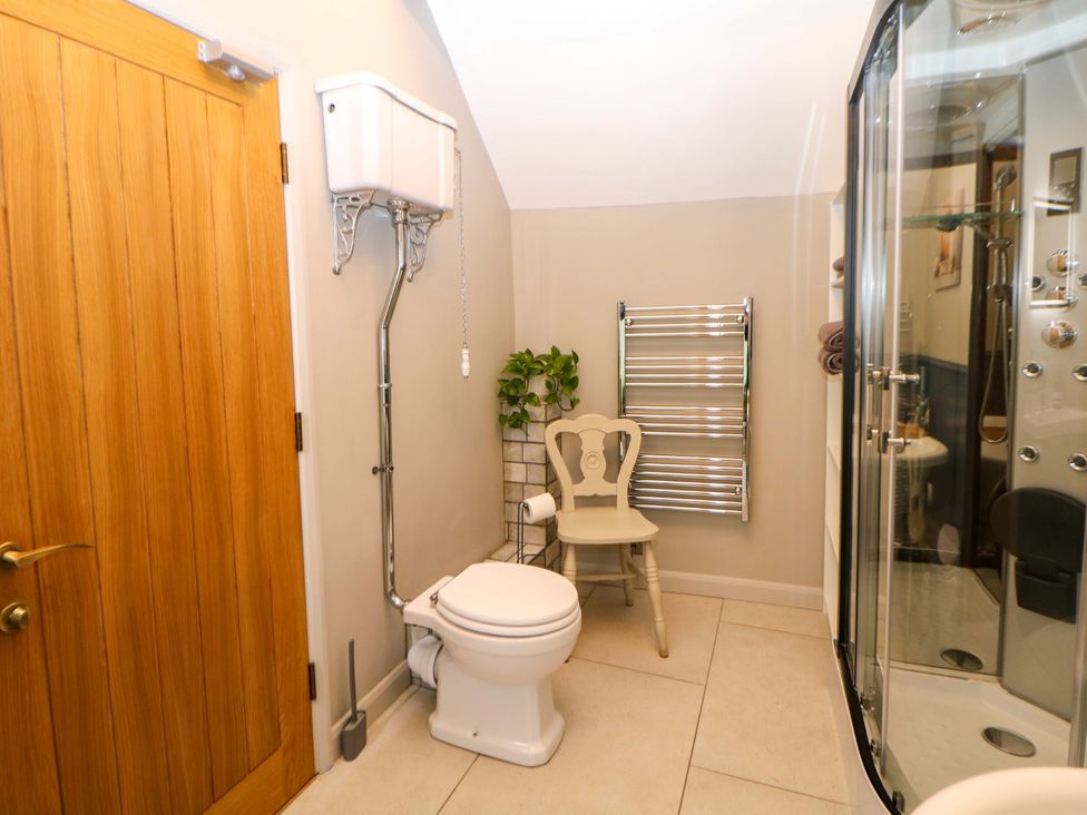 A bathroom with a toilet and shower at Horsedale Barn in Bonsall
