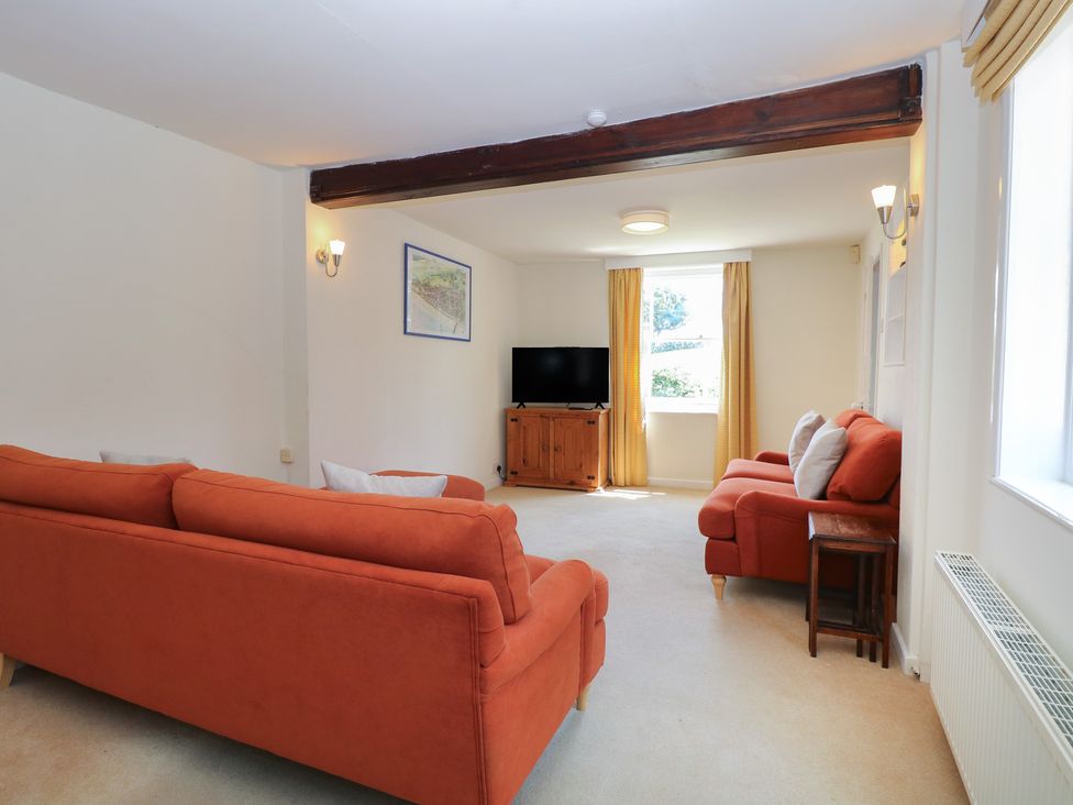 A living room with sofas and a television at Iona Cottage Southwold