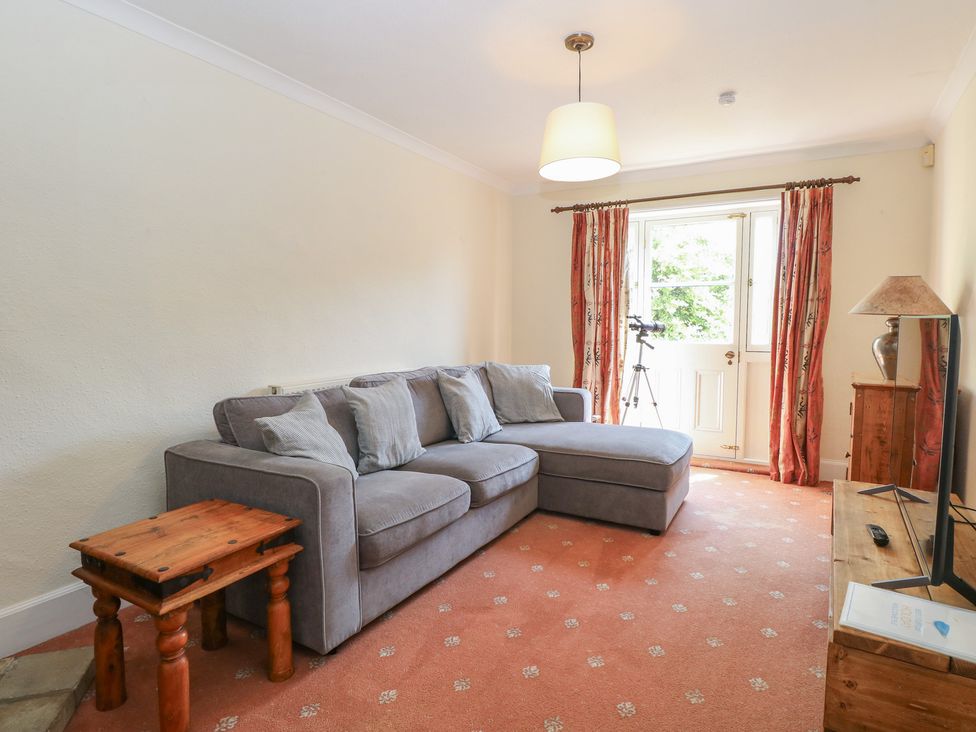 A living room with a sofa and coffee table at Iona Cottage Southwold