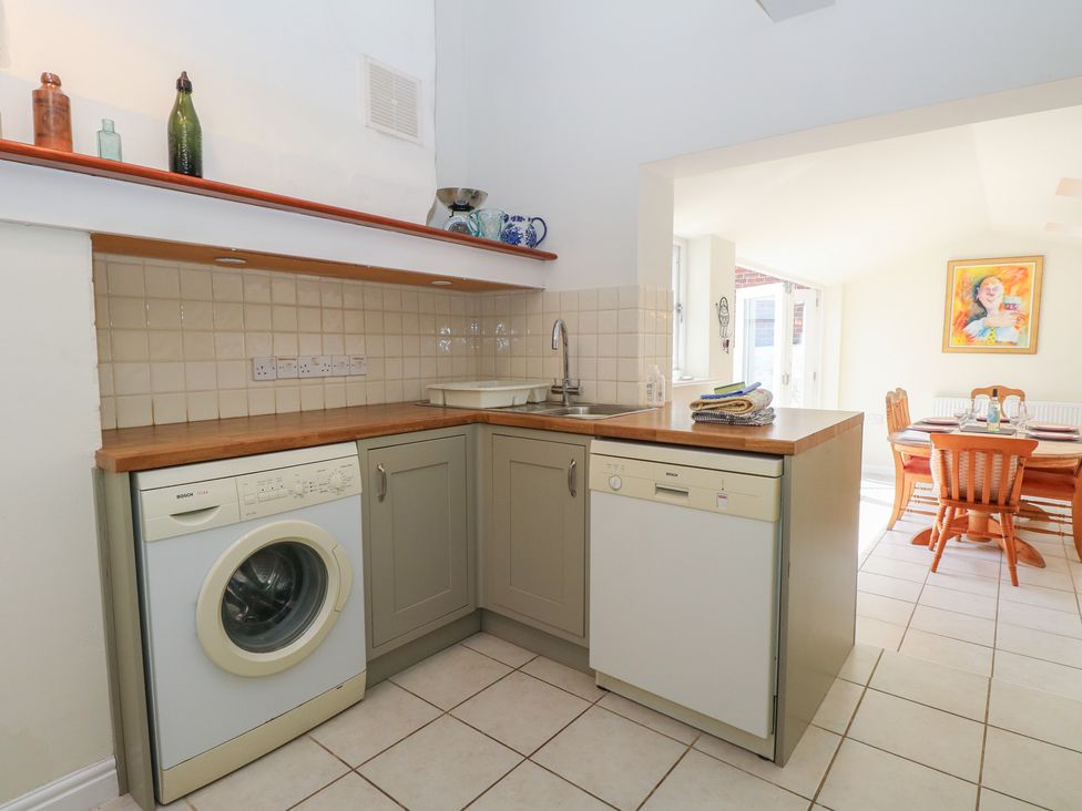 A kitchen with washing machine and dishwasher at Iona Cottage Southwold