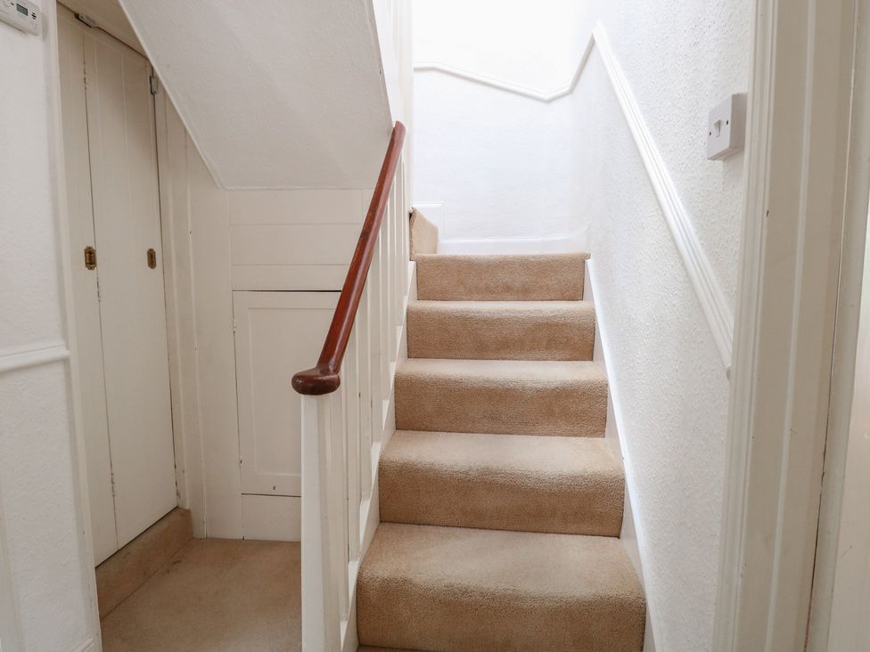 A staircase with a handrail at Iona Cottage Southwold