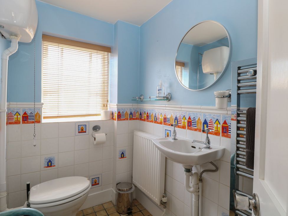 A bathroom with a toilet and sink at Iona Cottage Southwold