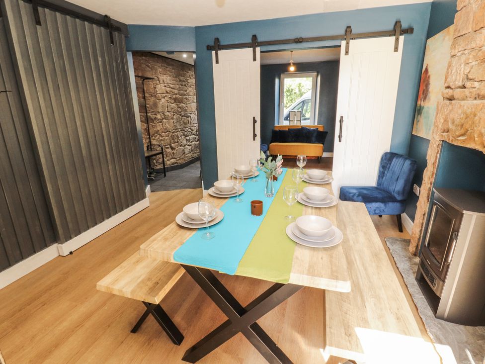 A dining room with a table set for a meal at 10 Keekle Terrace Cleator Moor