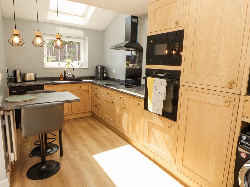 A kitchen with cabinets and appliances at 10 Keekle Terrace in Cleator Moor