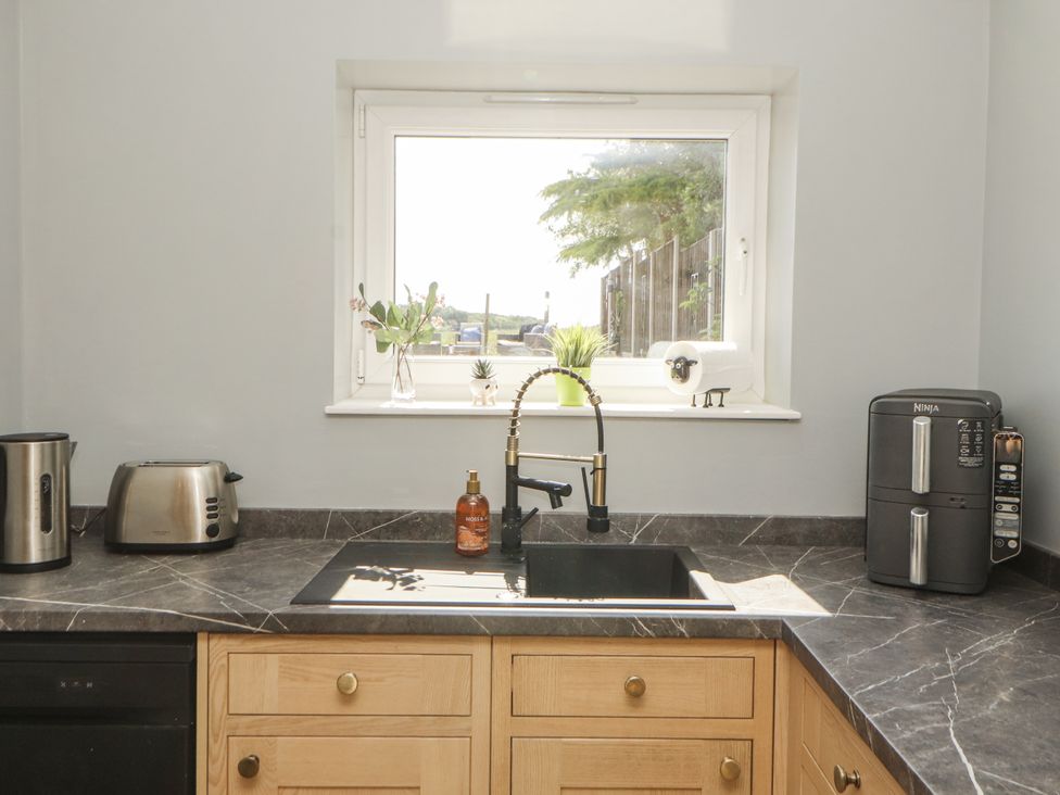 A kitchen with a sink, tap, kettle, and toaster at 10 Keekle Terrace in Cleator Moor