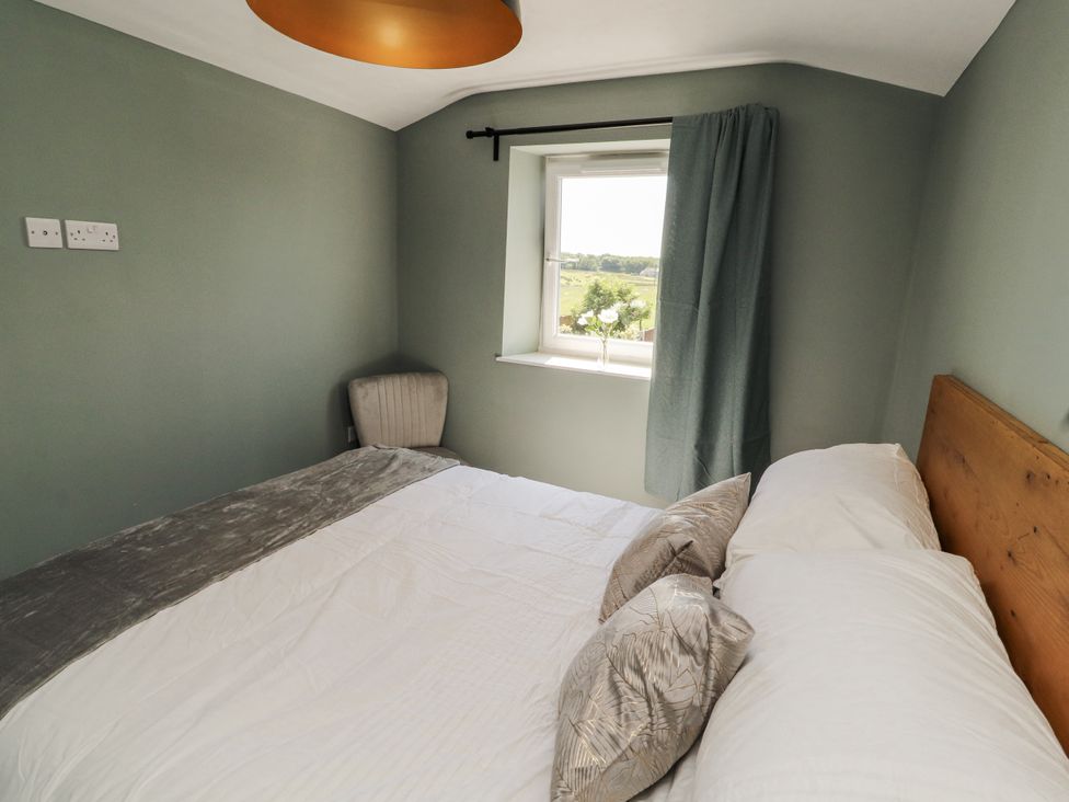 A bedroom with a bed and window at 10 Keekle Terrace in Cleator Moor