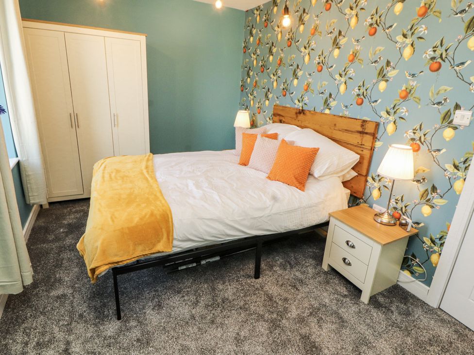 A bedroom with a bed and wardrobe at 10 Keekle Terrace in Cleator Moor