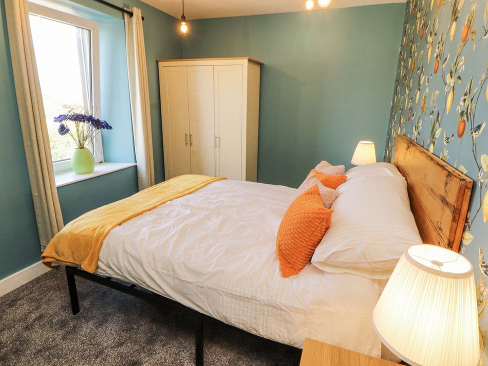 A bedroom with a bed and a closet at 10 Keekle Terrace in Cleator Moor