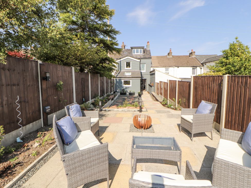 A garden with seating area and pathway at 10 Keekle Terrace in Cleator Moor