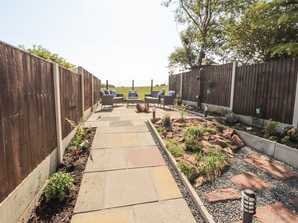 A garden area with paving stones and seating at 10 Keekle Terrace Cleator Moor