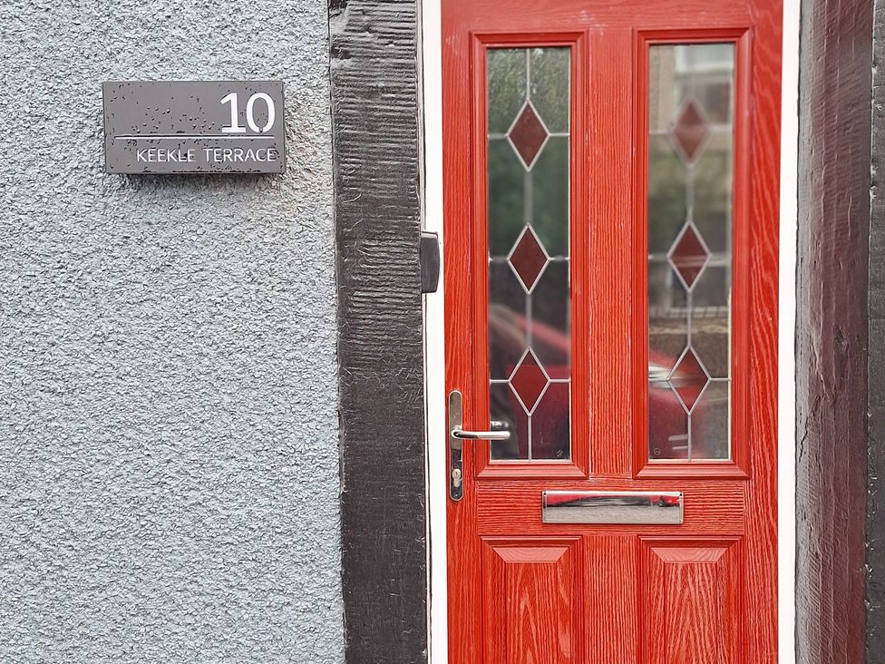 An entrance with a red door and nameplate at 10 Keekle Terrace in Keekle near Cleator Moor
