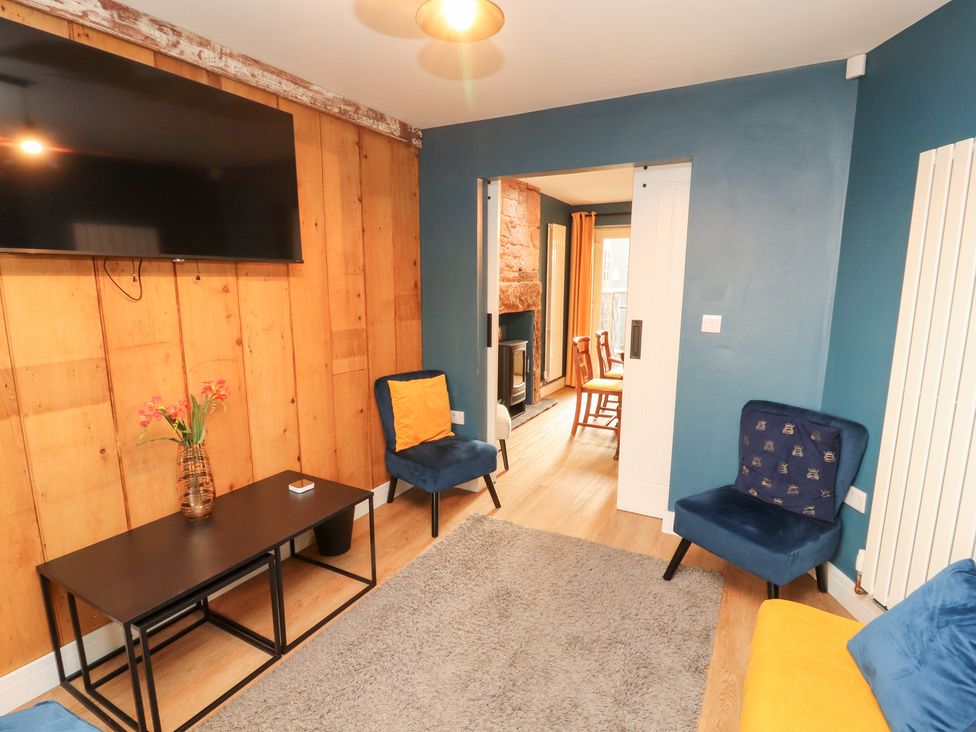 A living room with furniture and a television at 10 Keekle Terrace in Keekle near Cleator Moor