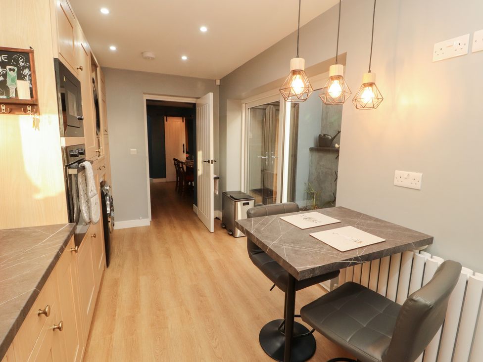 A kitchen with a table and chairs at 10 Keekle Terrace in Keekle near Cleator Moor
