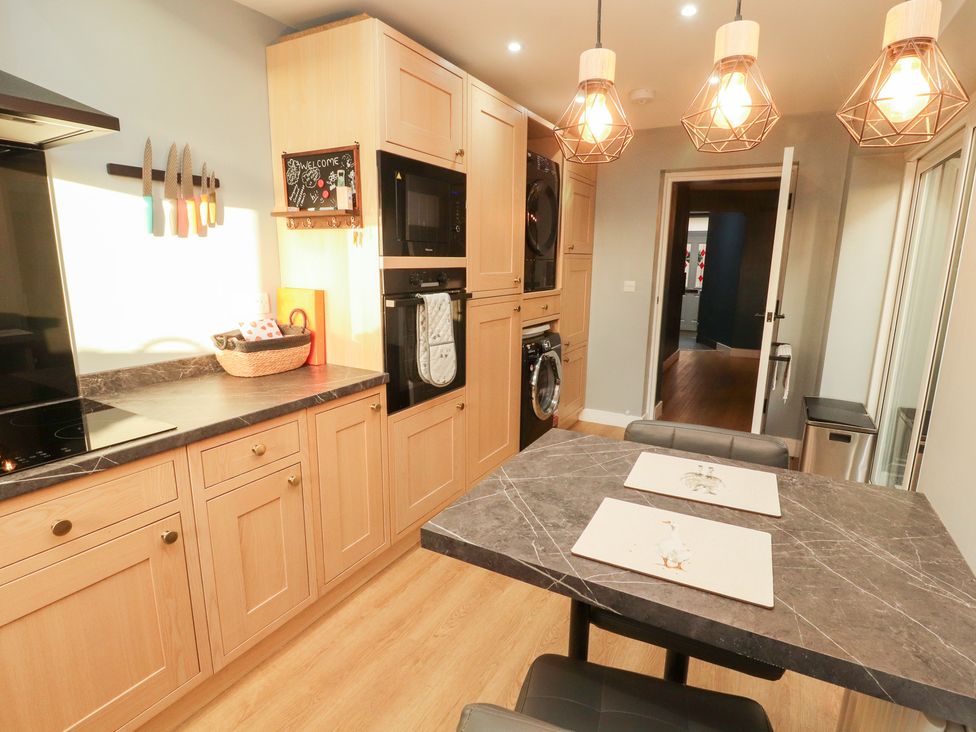 A kitchen with cabinets and appliances at 10 Keekle Terrace in Keekle near Cleator Moor