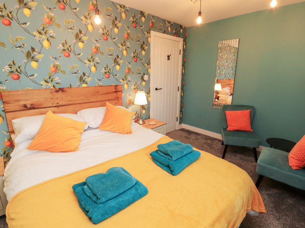 A bedroom with a bed and chair at 10 Keekle Terrace in Keekle near Cleator Moor