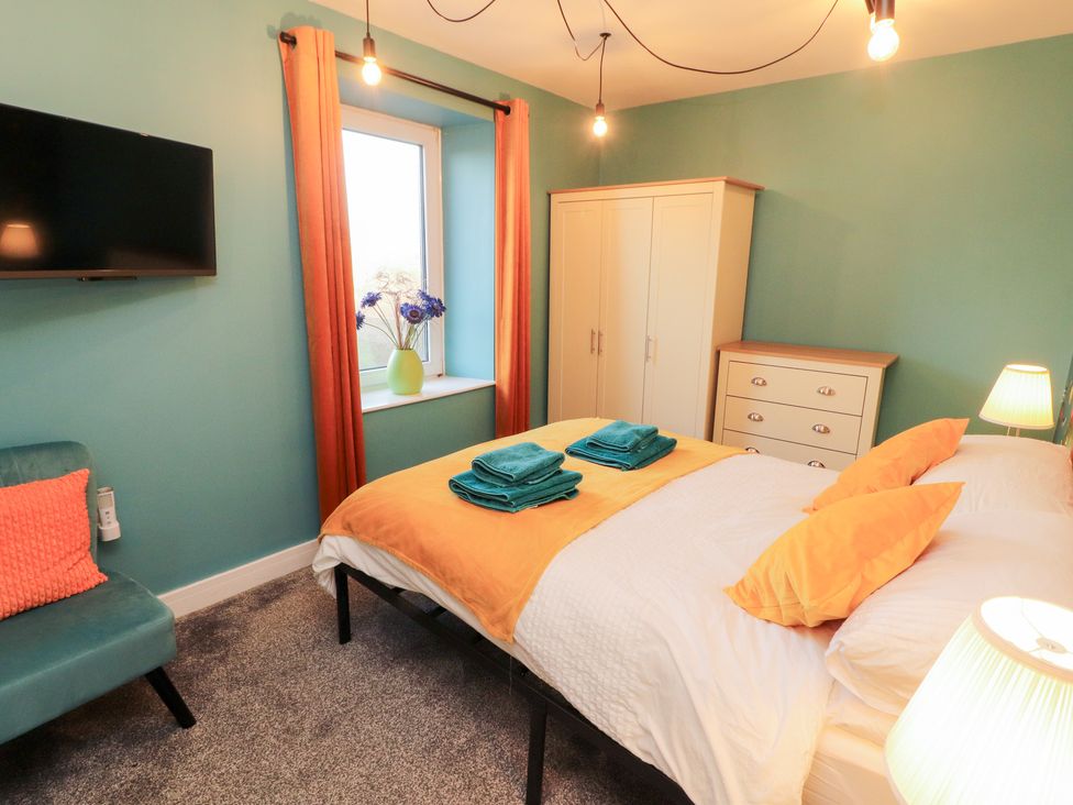 A bedroom with a bed and television at 10 Keekle Terrace in Keekle near Cleator Moor