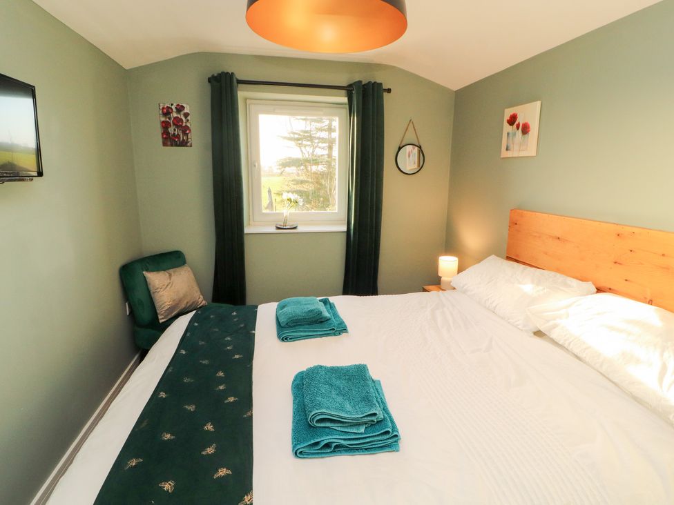 A bedroom with a bed and towels on it at 10 Keekle Terrace in Keekle near Cleator Moor