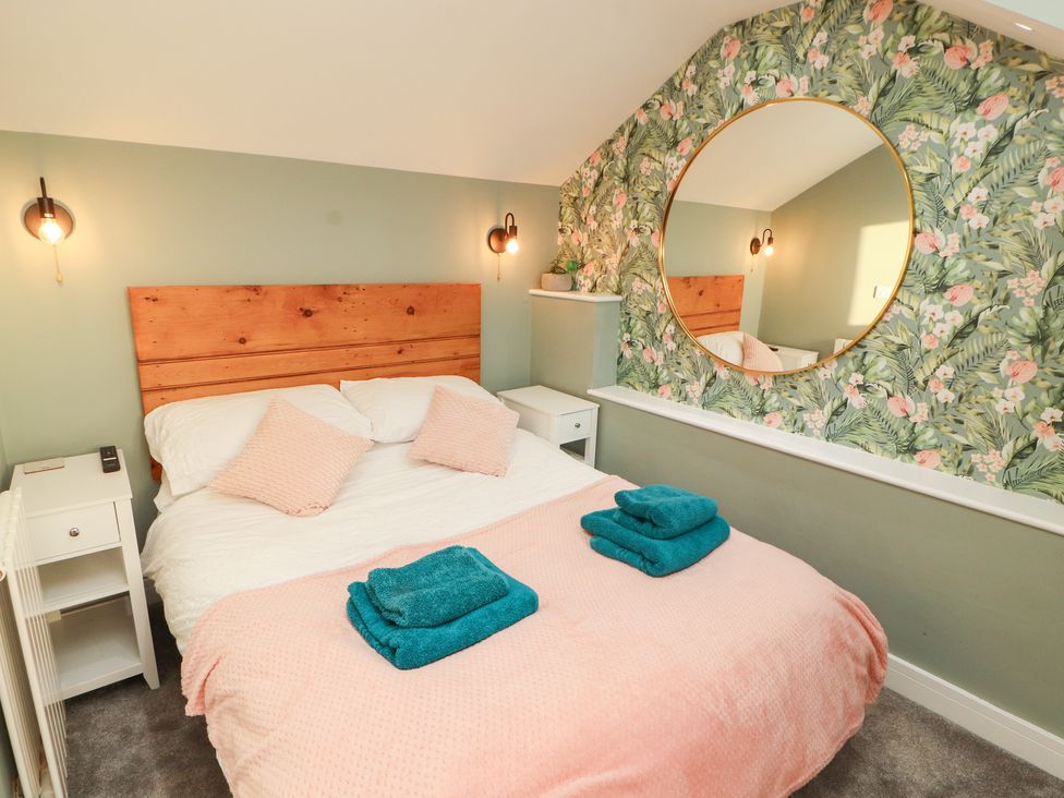 A bedroom with a bed and bedside table at 10 Keekle Terrace in Keekle near Cleator Moor