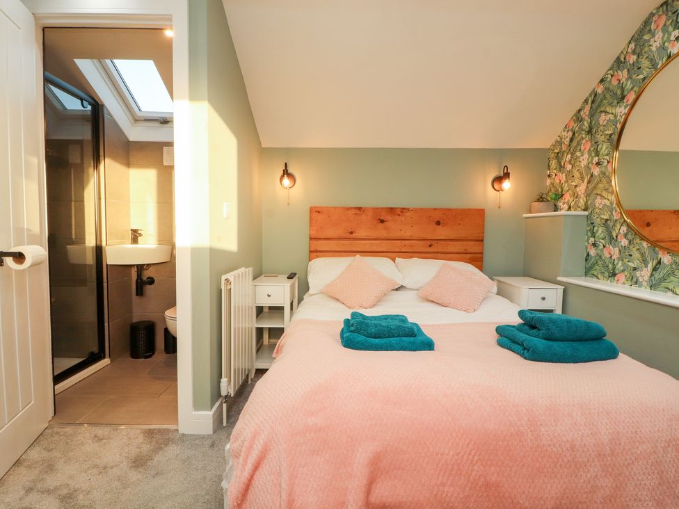 A bedroom with a bed and ensuite bathroom at 10 Keekle Terrace in Keekle near Cleator Moor