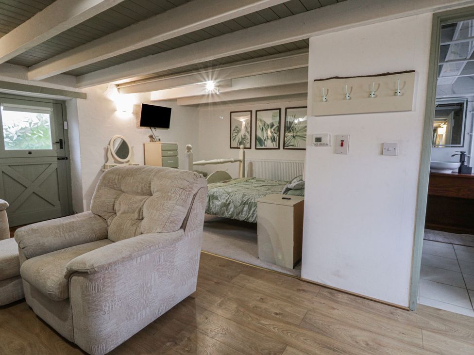 A bedroom with a bed and sofa at The Old Workshop in Dre-Fach near Lampeter