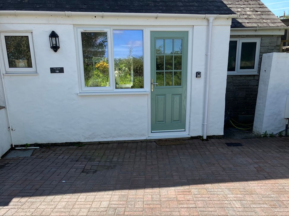 A front exterior view of a house with a green door at Elder Cottage Studio Perranwell Station near Ponsanooth