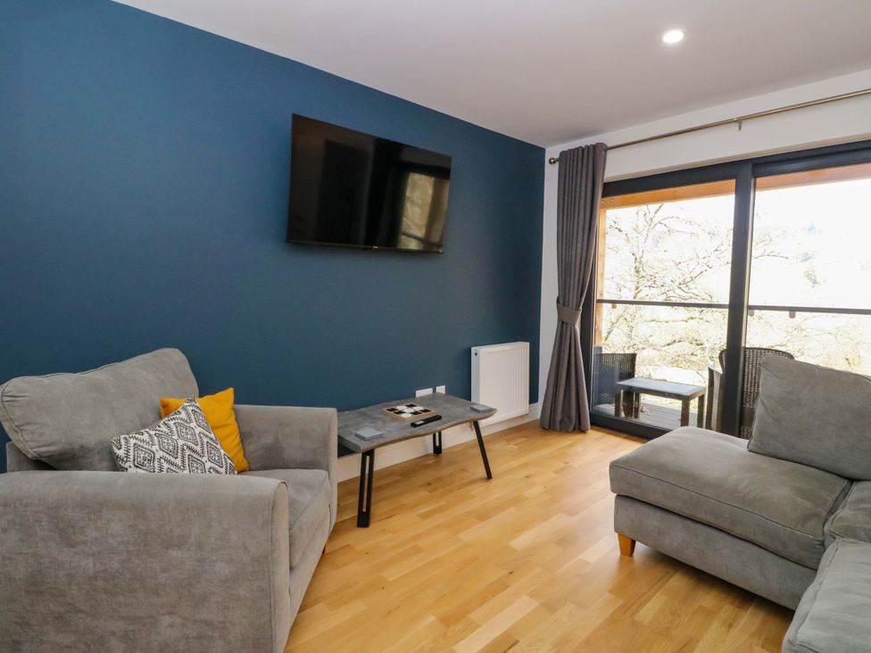 A living room with a sofa and television at 25 Strathtay Lodges in Aberfeldy