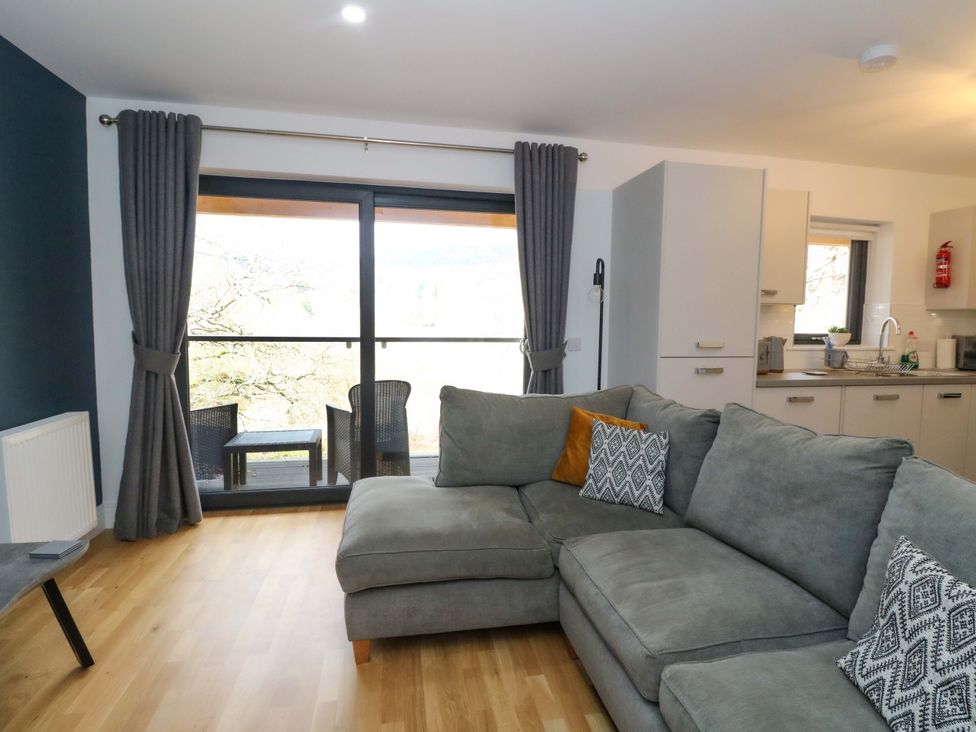 A living room with a sofa and a view at 25 Strathtay Lodges in Aberfeldy