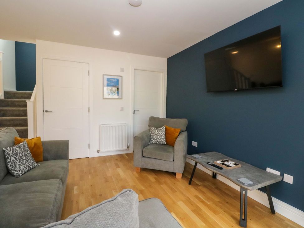 A living room with a sofa and television at 25 Strathtay Lodges in Aberfeldy