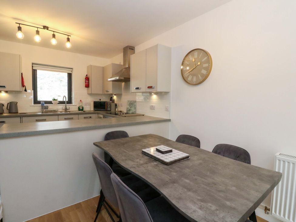 A kitchen with cabinets and appliances at 25 Strathtay Lodges in Aberfeldy