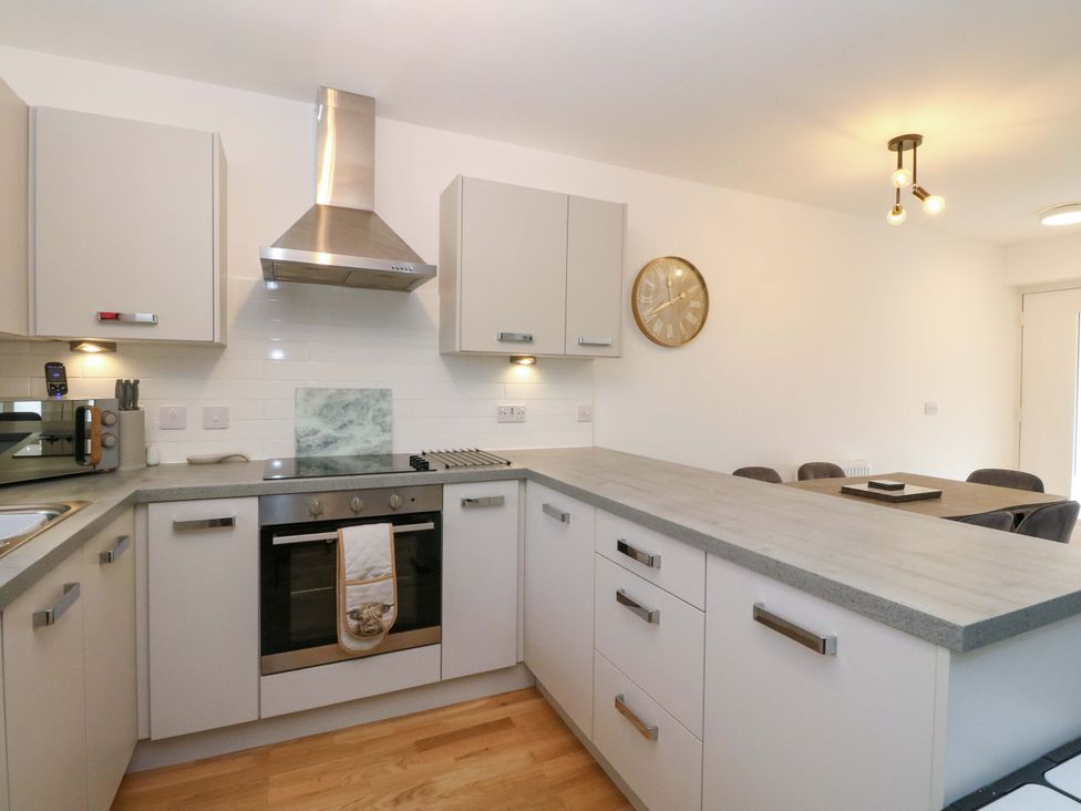 A kitchen with cabinets and appliances at 25 Strathtay Lodges Aberfeldy