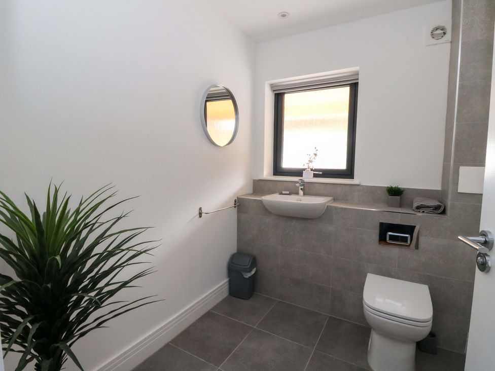 A bathroom with a sink, toilet, and window at 25 Strathtay Lodges Aberfeldy