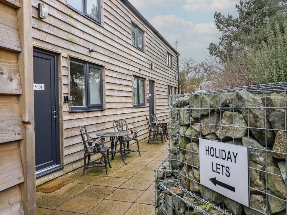 An outdoor seating area with a table and chairs at Ascot in Knolton near Ellesmere