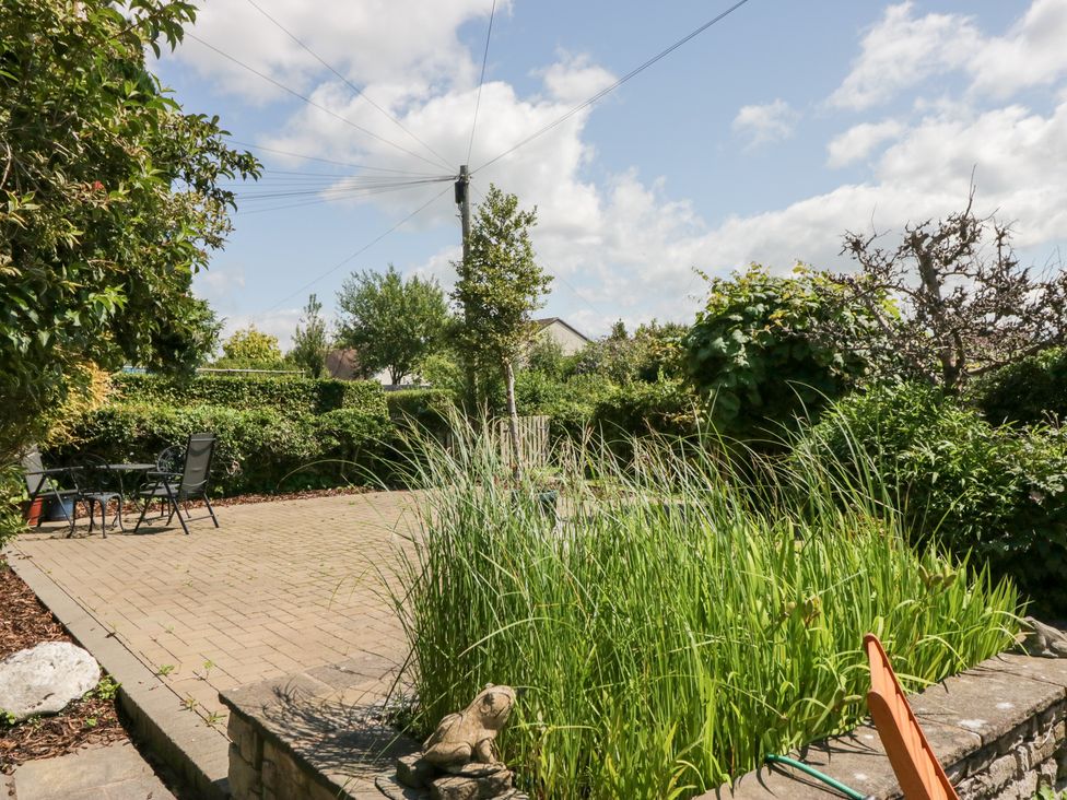 A garden with a patio and seating area at Timekeeper's Cottage Warton near Carnforth