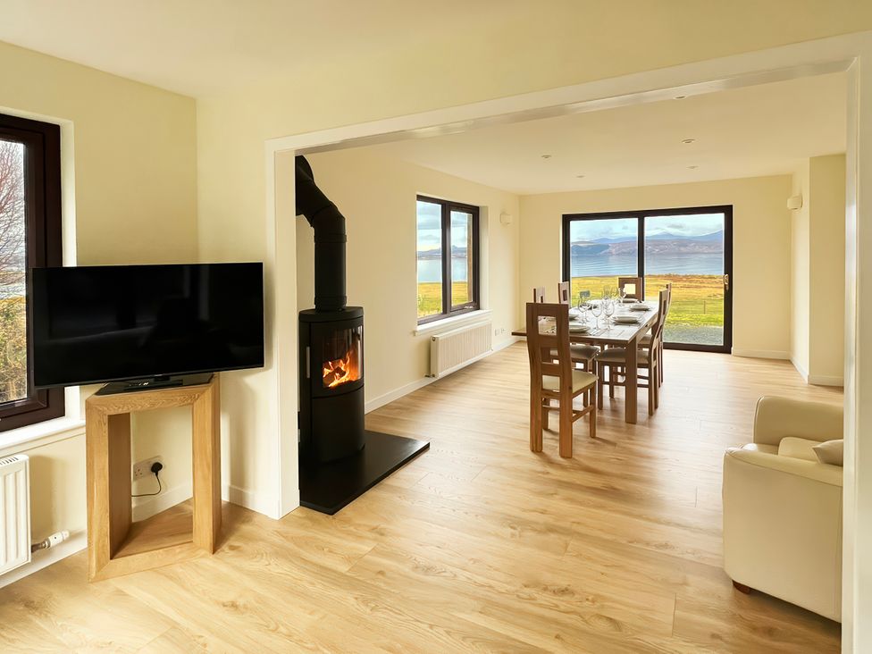 A dining room with a table and chairs at Calmdale in Inverasdale near Poolewe