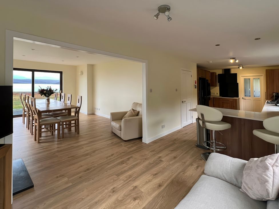 A dining room with a table and chairs at Calmdale in Inverasdale near Poolewe