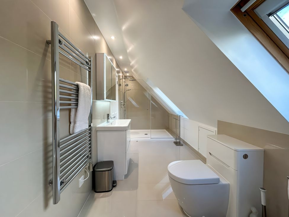 A bathroom with a shower and towel radiator at Calmdale in Inverasdale near Poolewe