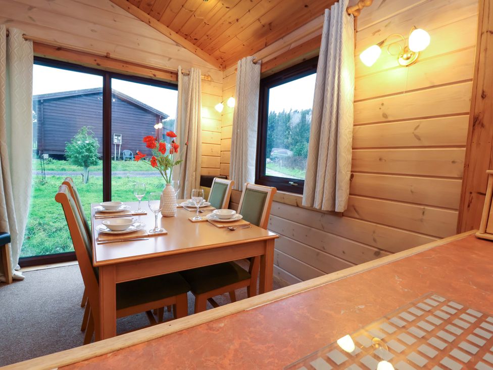A dining room with a table and chairs at Elderberrys Lodge, Bideford