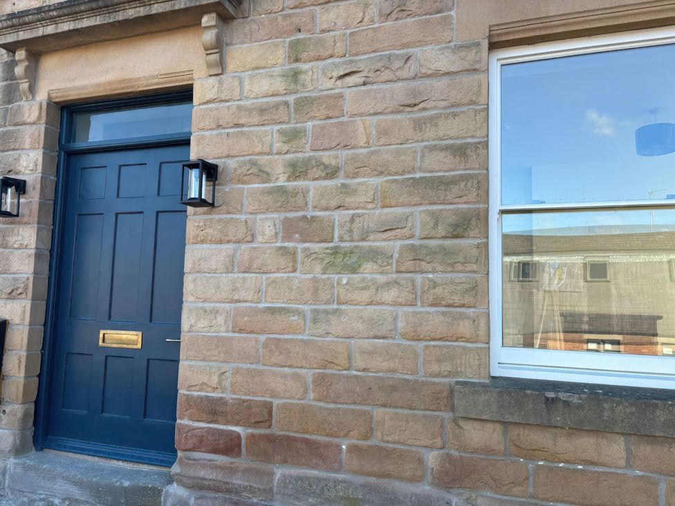 An entrance with a door and window at Holt Hall - Ground Floor Apartment in Matlock