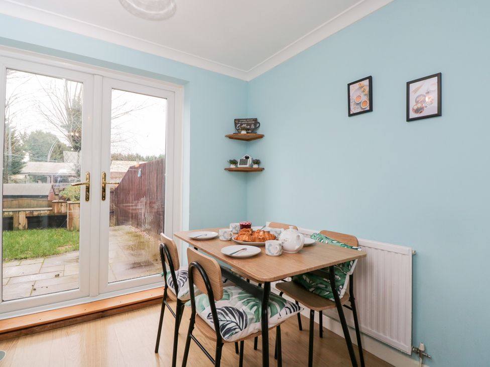 A dining room with a table set for breakfast at 20 Honeycroft in Bourton-On-The-Water