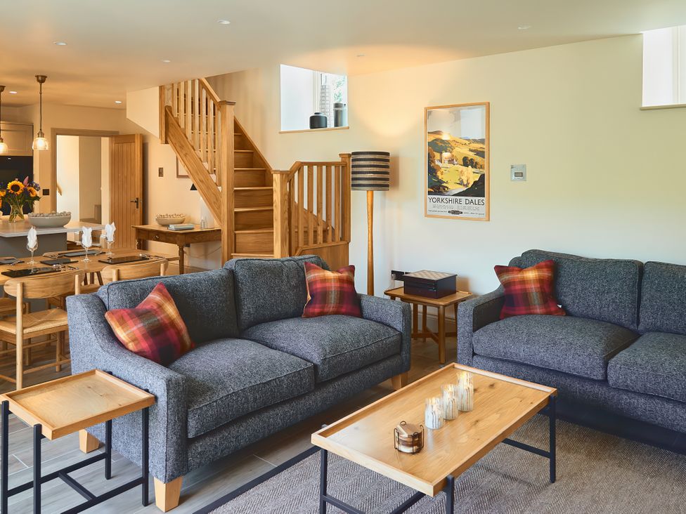 A living room with sofa and dining area at The Reading Rooms Oughtershaw near Buckden