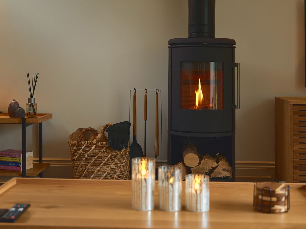 A living room with a fireplace and candles at The Reading Rooms Oughtershaw near Buckden