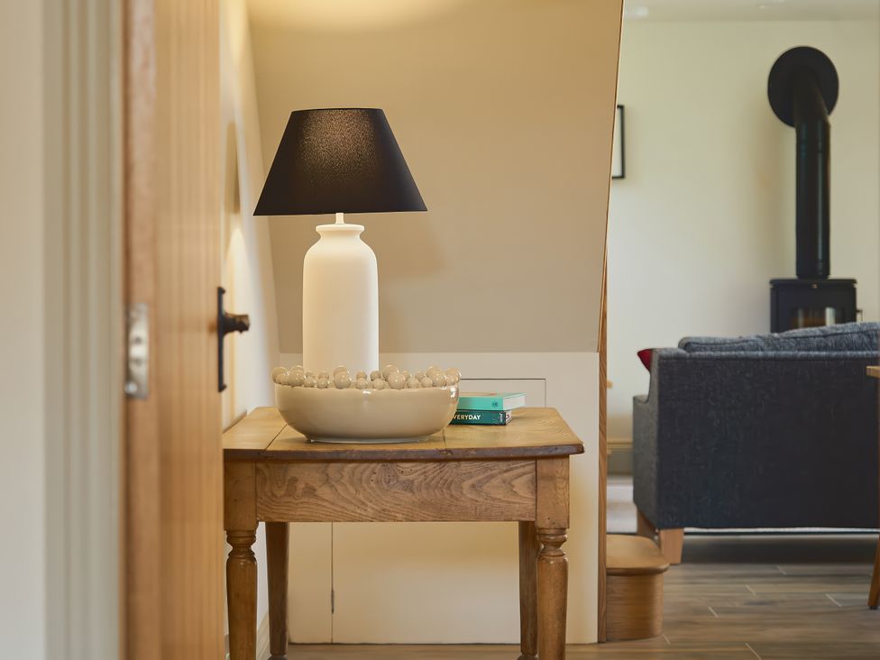 A table with a lamp and bowl in a living room at The Reading Rooms Oughtershaw near Buckden
