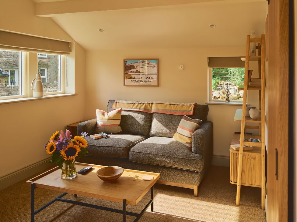 A living room with a sofa and coffee table at The Reading Rooms Oughtershaw near Buckden