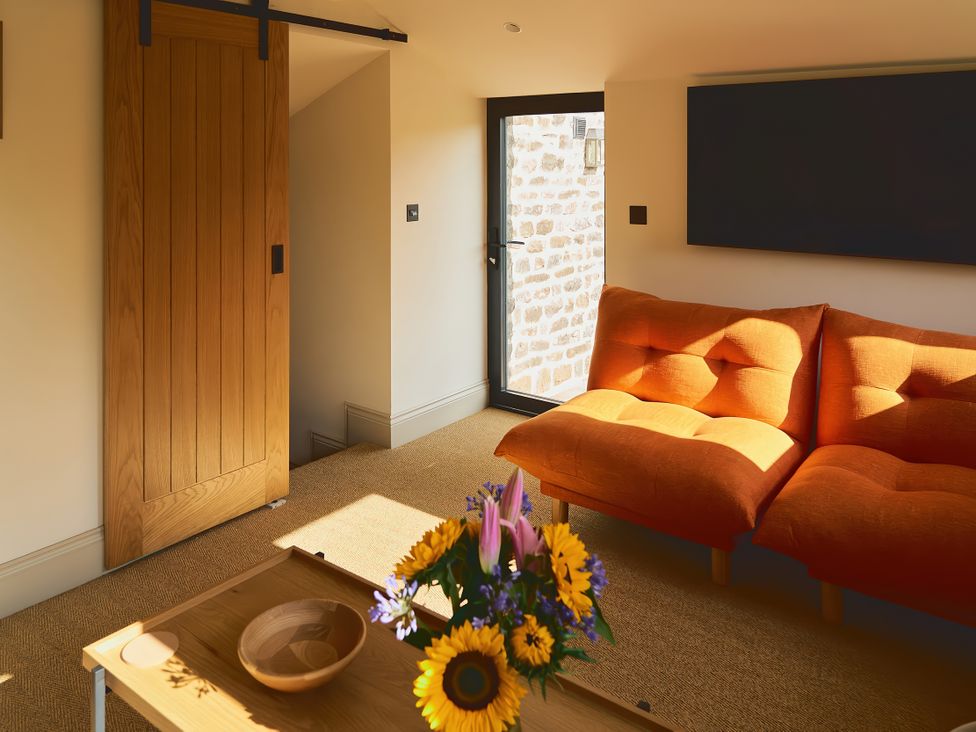 A living room with a sofa and coffee table at The Reading Rooms in Oughtershaw near Buckden