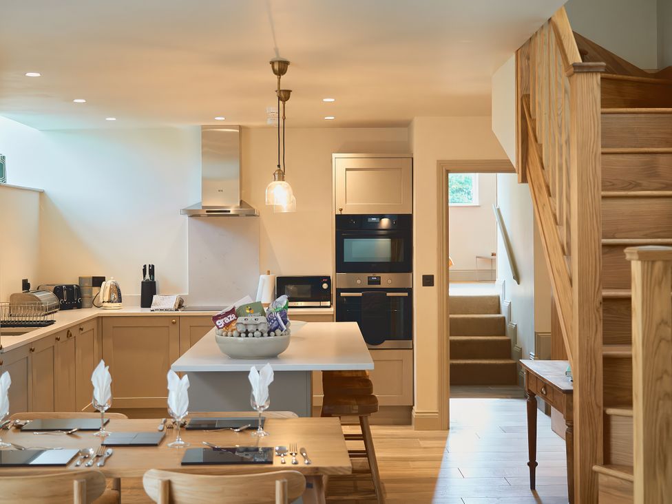 A kitchen with a dining table and appliances at The Reading Rooms in Oughtershaw near Buckden